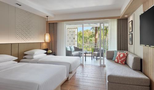 a hotel room with two beds and a balcony at Hyatt Regency Hua Hin in Hua Hin