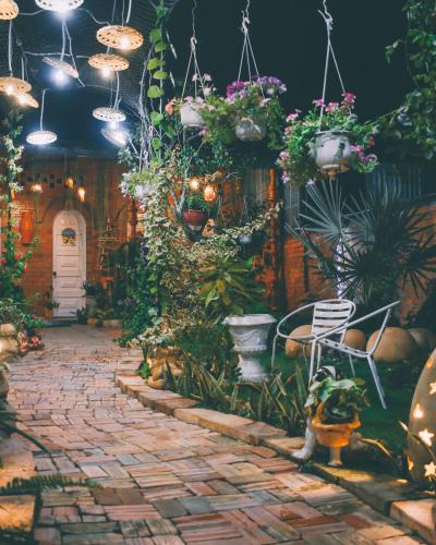 a brick walkway with potted plants in a garden at Mekong Pottery Homestay, Green-Friendly & Boat Tour in Vĩnh Long