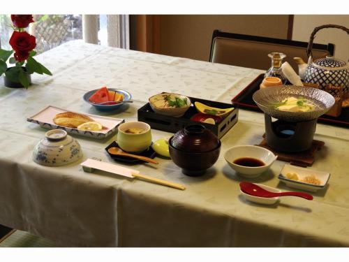 a table topped with bowls of food and chopsticks at Kyonoyado Kagihei in Kyoto