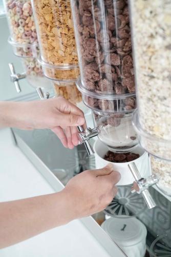 a woman is making food in a blender at Nantra Chiangmai Riverfront Hotel in Chiang Mai