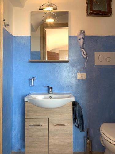 a bathroom with a sink and a mirror at Dammuso Giara in Pantelleria