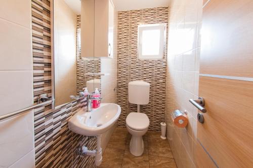 a small bathroom with a toilet and a sink at Apartments Anita in Split