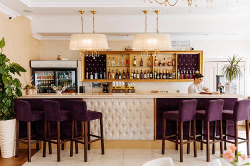 a woman sitting at a bar in a restaurant at Argo in Lviv