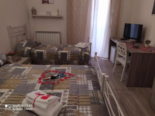 a small room with a bed and a desk at Alba Ionica Taranto in Taranto