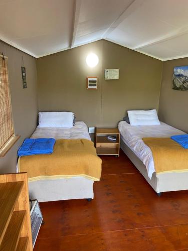 a room with two beds in a room at Pilot's Cabin, El Mirador Airfield in Champagne Valley