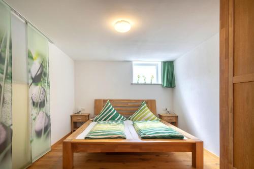 a bedroom with a bed with two pillows on it at Alpen-Hostel - Apartment Talstation mit Motorradvermietung in Memmingen