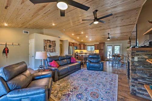 a living room with leather furniture and a fireplace at 1 Mi to Rainbow Lake Newly Built and Woodsy Retreat in Lake of the Woods