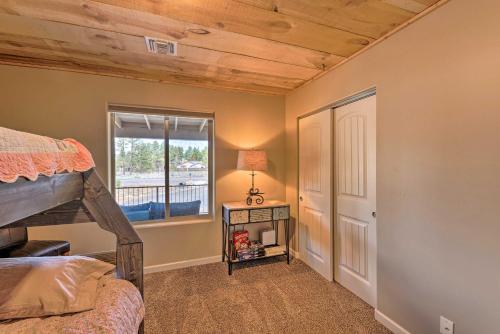 a bedroom with a bunk bed and a window at 1 Mi to Rainbow Lake Newly Built and Woodsy Retreat in Lake of the Woods