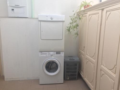 a washer and dryer in a white laundry room at Private apartment near Brussels in Asse