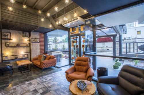 a lobby with leather chairs and a table at Elanis Suites in Antalya