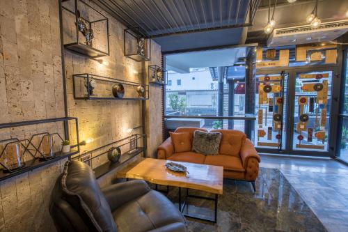 a living room with a couch and a table at Elanis Suites in Antalya