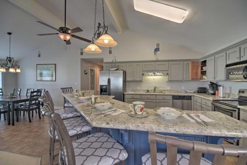 a kitchen with a large island with chairs in it at Fish at Canalfront Bay St Louis Home - Dock and Deck in Shoreline Park
