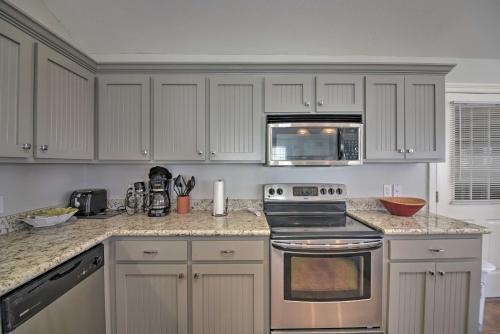 a kitchen with white cabinets and a stove top oven at Fish at Canalfront Bay St Louis Home - Dock and Deck in Shoreline Park