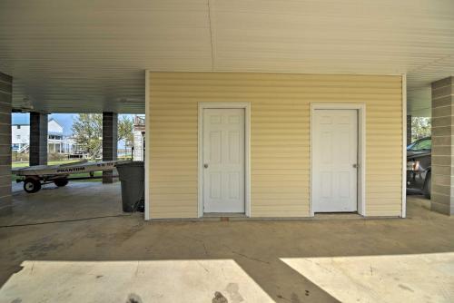 a building with two white doors in a garage at Fish at Canalfront Bay St Louis Home - Dock and Deck in Shoreline Park