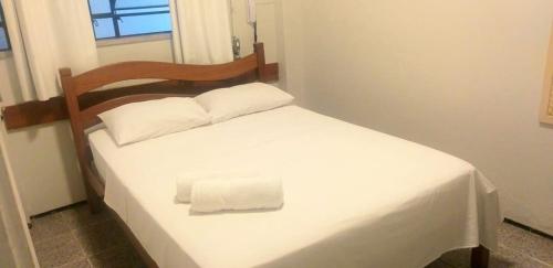 a small white bed with a towel on it at Hotel Meireles in Fortaleza