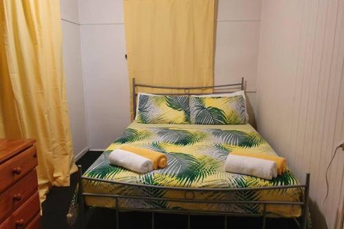 a bed with two pillows on it in a bedroom at Meyenburg Unit 1 in Mount Morgan