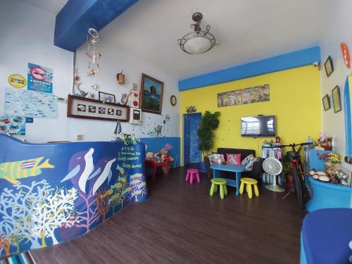 a room with a play area with tables and chairs at Captain Homestay in Eluan
