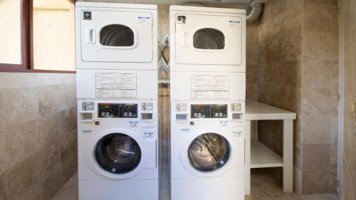 two washing machines sitting next to each other in a laundry room at Holiday Inn Queretaro Centro Historico by IHG in Querétaro