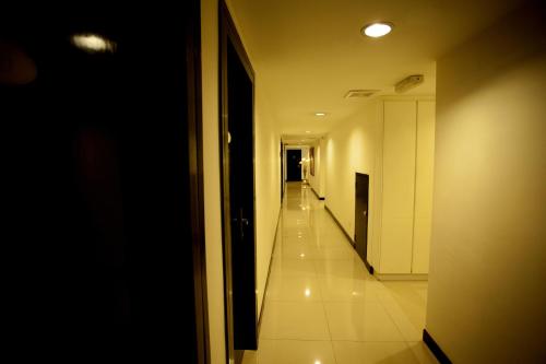 a hallway of a building with a long corridor at Mangga Boutique Hotel in Seri Kembangan
