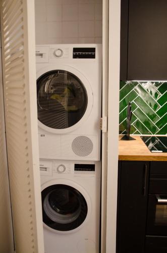 a washer and dryer stacked in a kitchen at Dorpsplein Appartement in Zandvoort