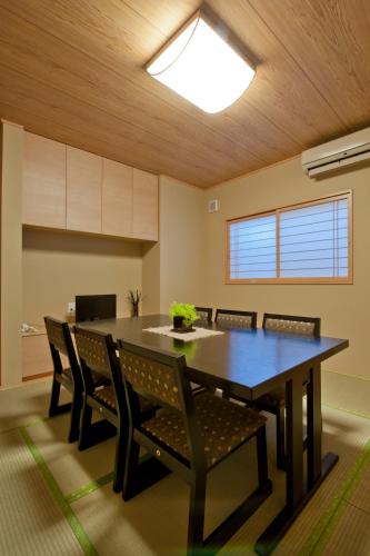 a dining room with a table and chairs at Hinode Ryokan in Ise