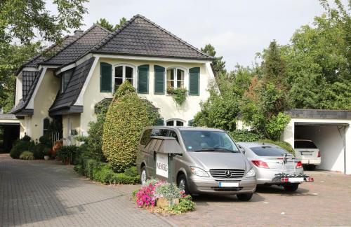 a van parked in a parking lot in front of a house at Gästehaus Niemerg in Warendorf