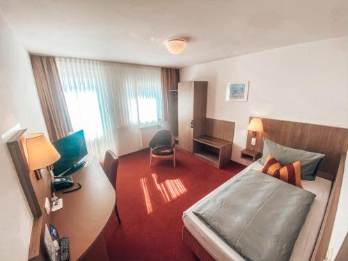 Postel nebo postele na pokoji v ubytování Hotel Schwertfirm