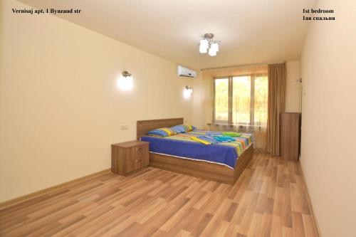 a bedroom with a bed and a wooden floor at Vernisaj apt at Republic Square & Ruben tours in Yerevan
