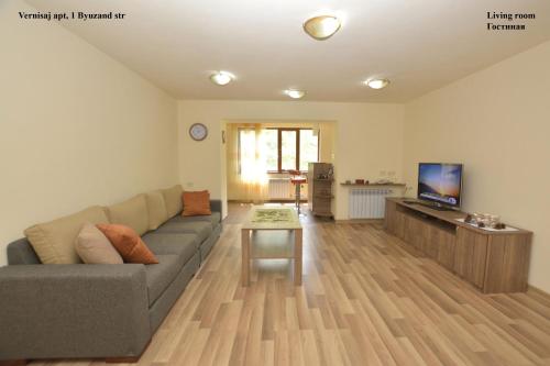 a living room with a couch and a table at Vernisaj apt at Republic Square & Ruben tours in Yerevan