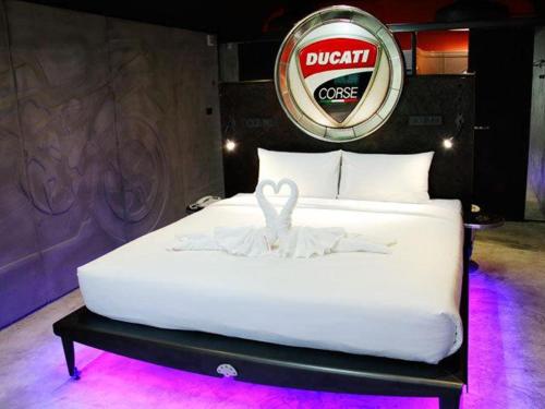a white bed with a bunny on top of it at Nicky's Handlebar in Patong Beach