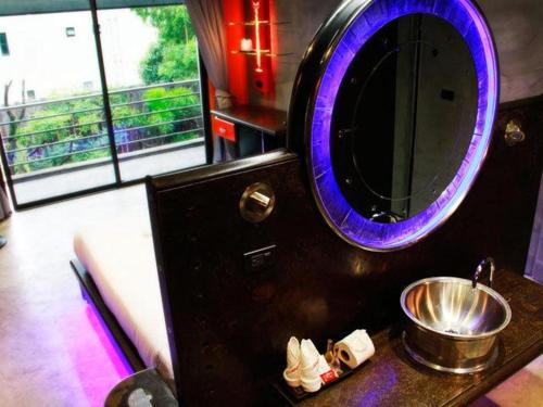 a bathroom with a purple mirror and a sink at Nicky's Handlebar in Patong Beach