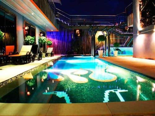 a swimming pool in the middle of a building at Nicky's Handlebar in Patong Beach