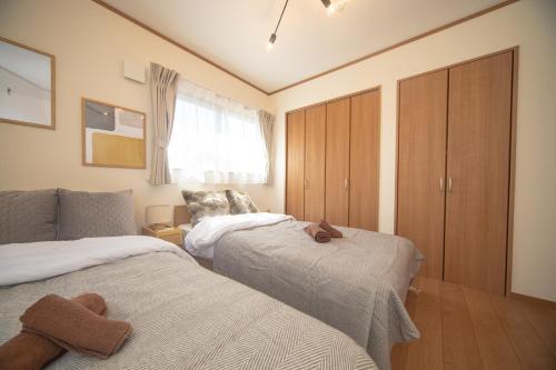 Postel nebo postele na pokoji v ubytování Ritz Residence 墨田