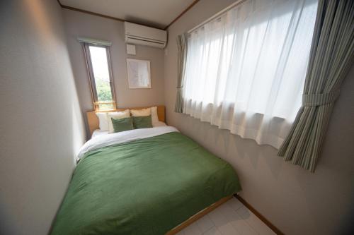 Postel nebo postele na pokoji v ubytování Ritz Residence 墨田