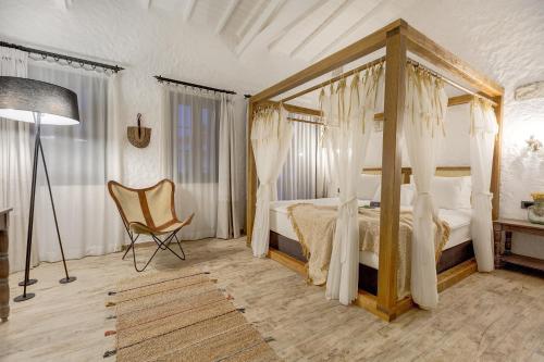 A bed or beds in a room at Alachi Hotel