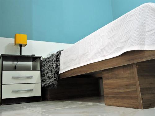 a bed with a mattress and a dresser underneath it at 10 Studios in Sao Paulo