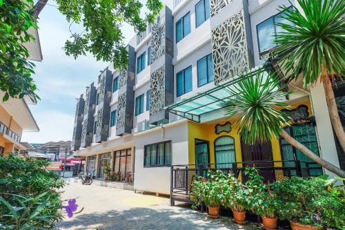 a building with plants in front of it at The Little Nest Phuket in Phuket