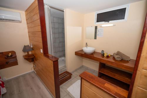 a bathroom with a sink and a shower at BORA BORA HOLIDAY'S LODGE in Bora Bora