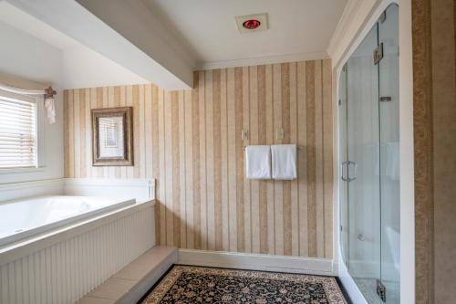 a bathroom with a tub and a shower at The Inn at Thorn Hill in Jackson