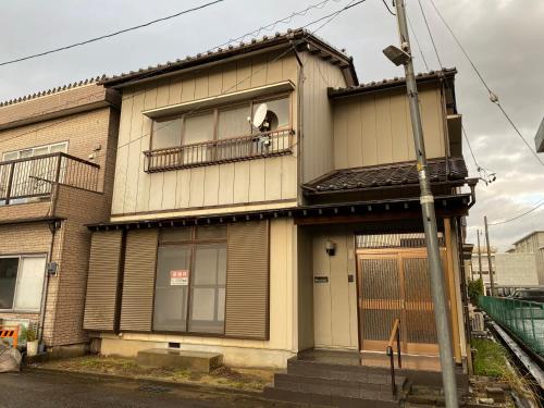 a building with a dog sticking its head out of a window at Yasunoya #HH2x in Toyama
