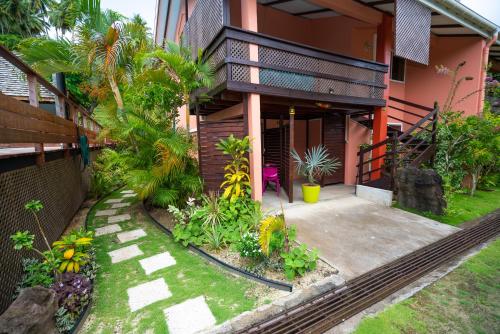 a house with a walkway in front of it at BORA BORA HOLIDAY'S LODGE in Bora Bora