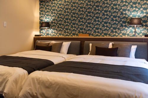 Кровать или кровати в номере Bijou Suites Miyabi