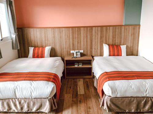 Una cama o camas en una habitación de 金銀花民宿