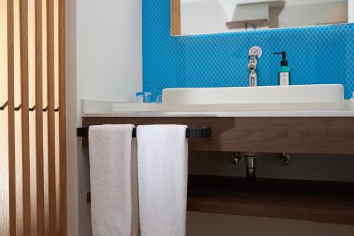 a bathroom with a sink and two towels at Holiday Inn Express Hangzhou Jiuzhou by IHG in Hangzhou
