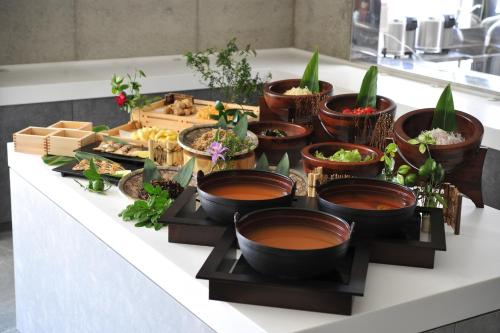 a buffet of food on a table with plants at The BREAKFAST HOTEL PORTO Ishigakijima in Ishigaki Island