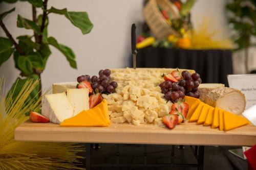 a cutting board with cheese and fruit on a table at Holiday Inn Orlando International Airport by IHG in Orlando