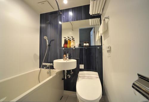 a bathroom with a toilet and a sink at The BREAKFAST HOTEL PORTO Ishigakijima in Ishigaki Island