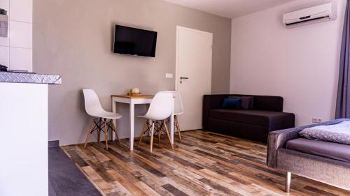 a living room with a couch and a table and chairs at Racers Home Nürburg in Nürburg