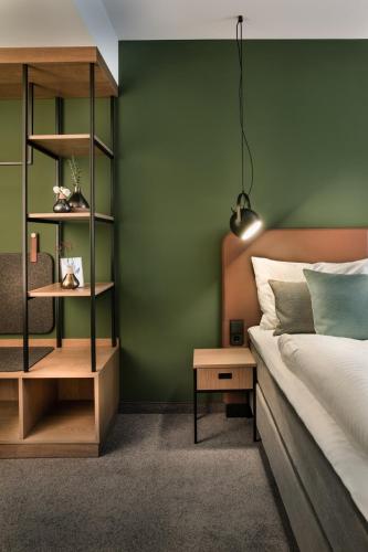 a bedroom with a bed and a green wall at Domizil Tübingen in Tübingen