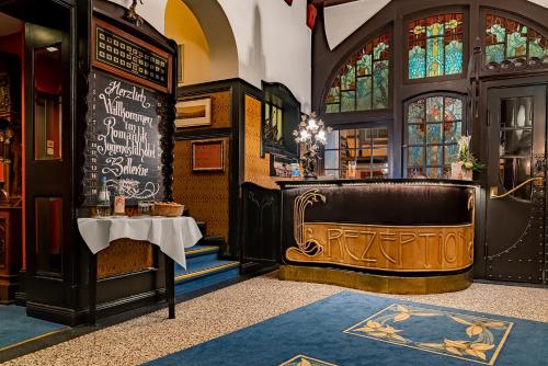 a bar with a bench in a room with stained glass at Romantik Jugendstilhotel Bellevue in Traben-Trarbach